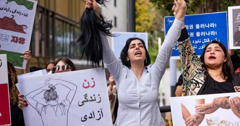 A member of the Iranian community in Seoul cuts her hair outside the Embassy of the Islamic Republic of Iran