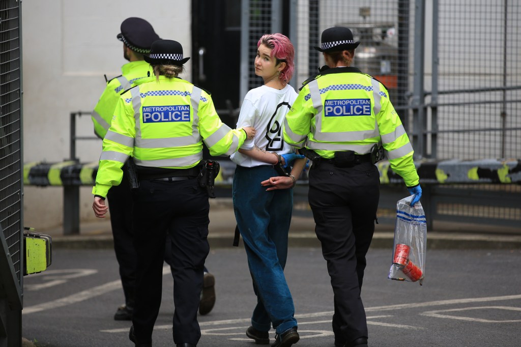 Phoebe Plummer is led away by police officers 