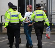 Phoebe Plummer is led away by police officers