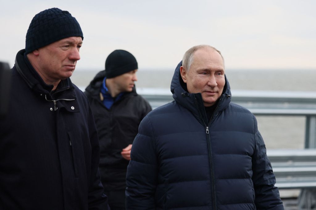Vladimir Putin standing next to Marat Khusnullin as they walk across the Crimean bridge.