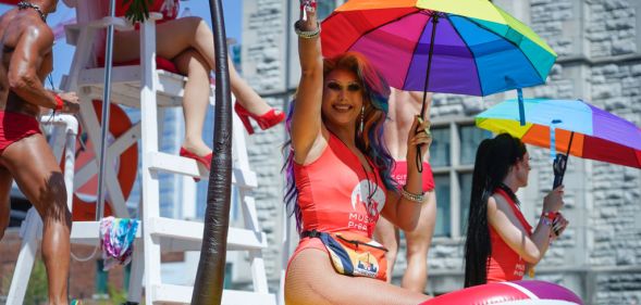 A photo of A drag queen holding an umbrella with Pride rainbow colours on a float at Nashville Pride parade
