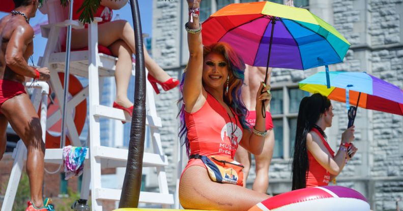 A photo of A drag queen holding an umbrella with Pride rainbow colours on a float at Nashville Pride parade