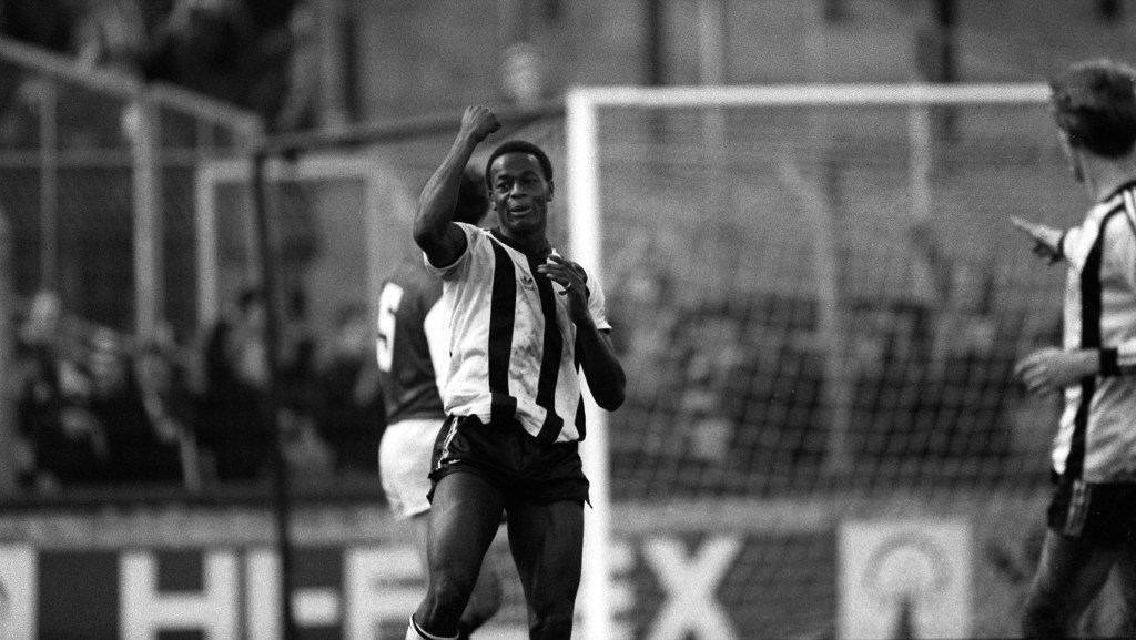 A black and white photo showing Norwich City footballer Justin Fashanu in action during a game in 1983