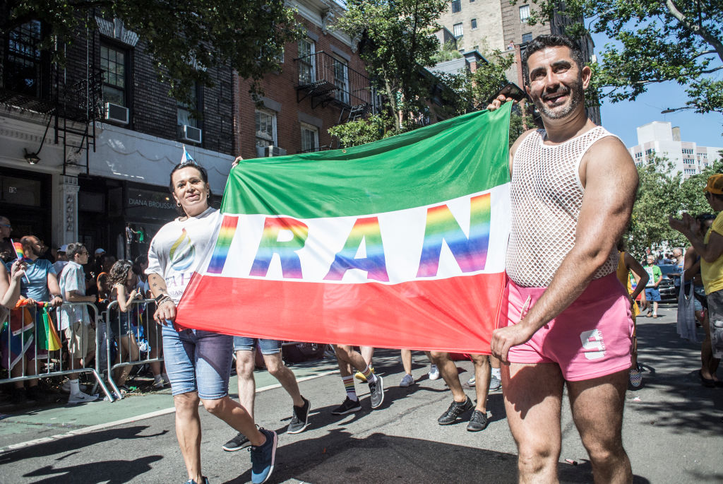 Gay Iranian marchers holding a flag that reads IRAN during the Gay Pride Parade on June 30, 2019 in New York City.