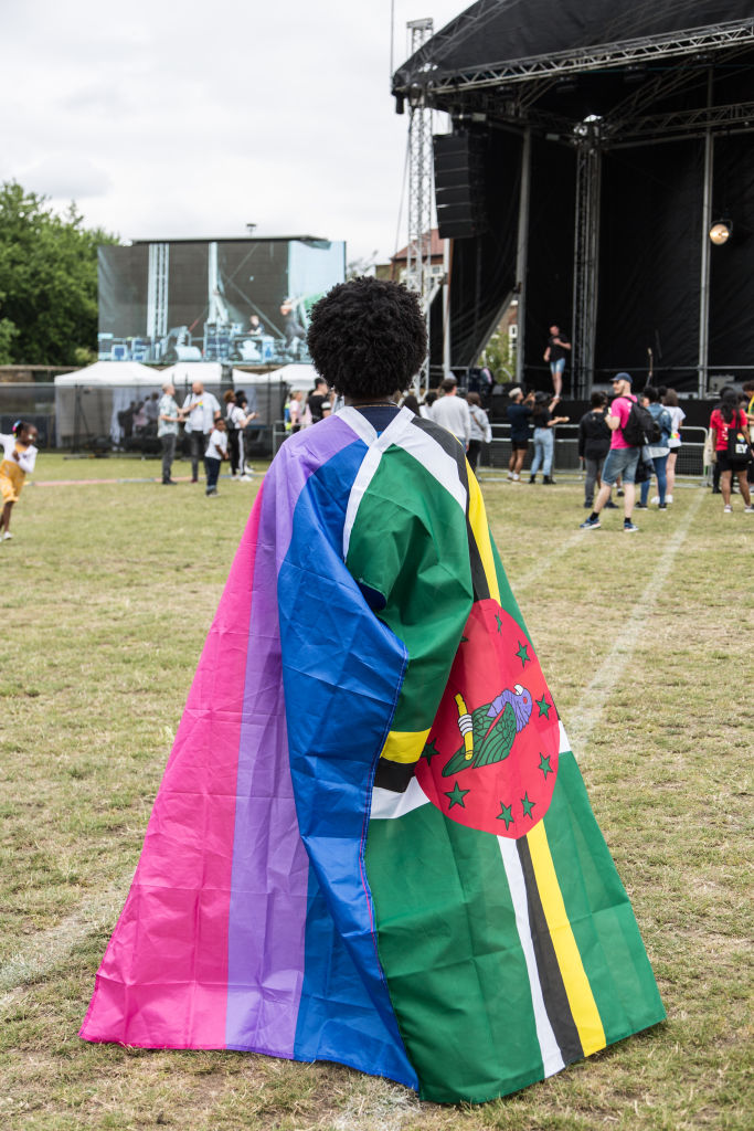 A visitor with the LGBTQ+ and Jamaica flag at the UK Black Pride event in Haggerston Park in London, United Kingdom, on July 7th, 2019.