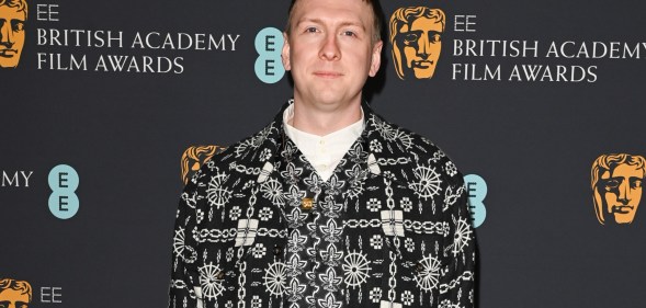 A photo of comedian Joe Lycett wearing a black and white patterned suit jacket over a white top at the Bafta awards ceremony. (Getty)