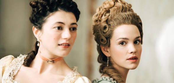A promotional still from new BBC Two series Marie Antoinette showing actors Jasmine Blackborow and Emilia Schule as Lamballe and Marie Antoinette - dressed in their period costumes and standing next to each other