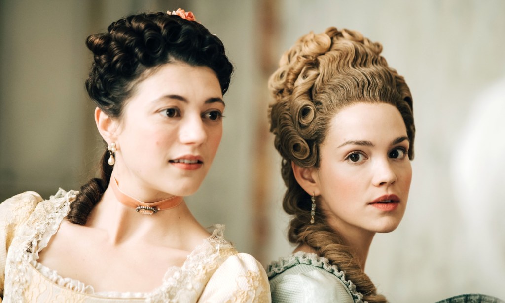 A promotional still from new BBC Two series Marie Antoinette showing actors Jasmine Blackborow and Emilia Schule as Lamballe and Marie Antoinette - dressed in their period costumes and standing next to each other