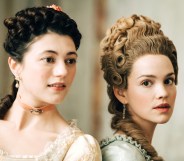 A promotional still from new BBC Two series Marie Antoinette showing actors Jasmine Blackborow and Emilia Schule as Lamballe and Marie Antoinette - dressed in their period costumes and standing next to each other