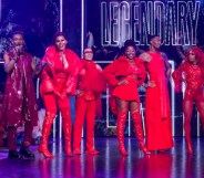 A screengrab from HBO's Legendary showing its contestants dressed in their red outfits on stage and also standing to the side dressed in his purple outfit is actor and dancer Dashaun Wesley who is the MC in the show.(HBO Max)
