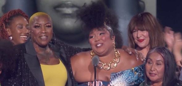 Lizzo surrounded by activists, (NBC)