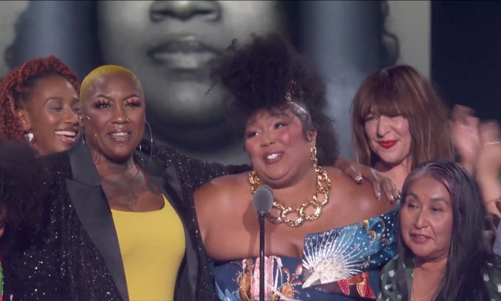 Lizzo surrounded by activists, (NBC)