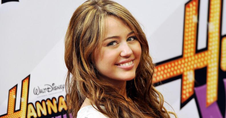 US actress Miley Cyrus, who later came out as LGBTQ, poses for photographers on the red carpet for the film "Hannah Montana - The Movie" in the southern German city of Munich on April 25, 2009. The film is set to open on June 1, 2009 in the German cinemas. AFP PHOTO DDP / JOERG KOCH GERMANY OUT (Photo credit should read JOERG KOCH/DDP/AFP via Getty Images)