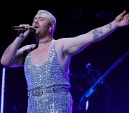 A photo shows Sam Smith wearing a sparkly jumpsuit while performing at Capital Jingle Bell Ball. (Getty)