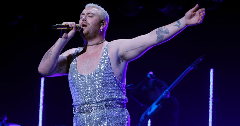 A photo shows Sam Smith wearing a sparkly jumpsuit while performing at Capital Jingle Bell Ball. (Getty)