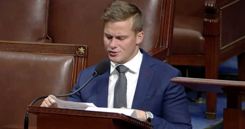 Dressed in a navy blue suit, white shirt and grey tie Madison Cawthorn gives his final address at the House of Representatives, sat a podium and talking into a microphone