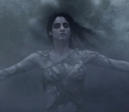 A still from The Mummy (2017) featuring the Mummy played by actress Sofia Boutella with her arms out and eyes closed while being covered in a mist