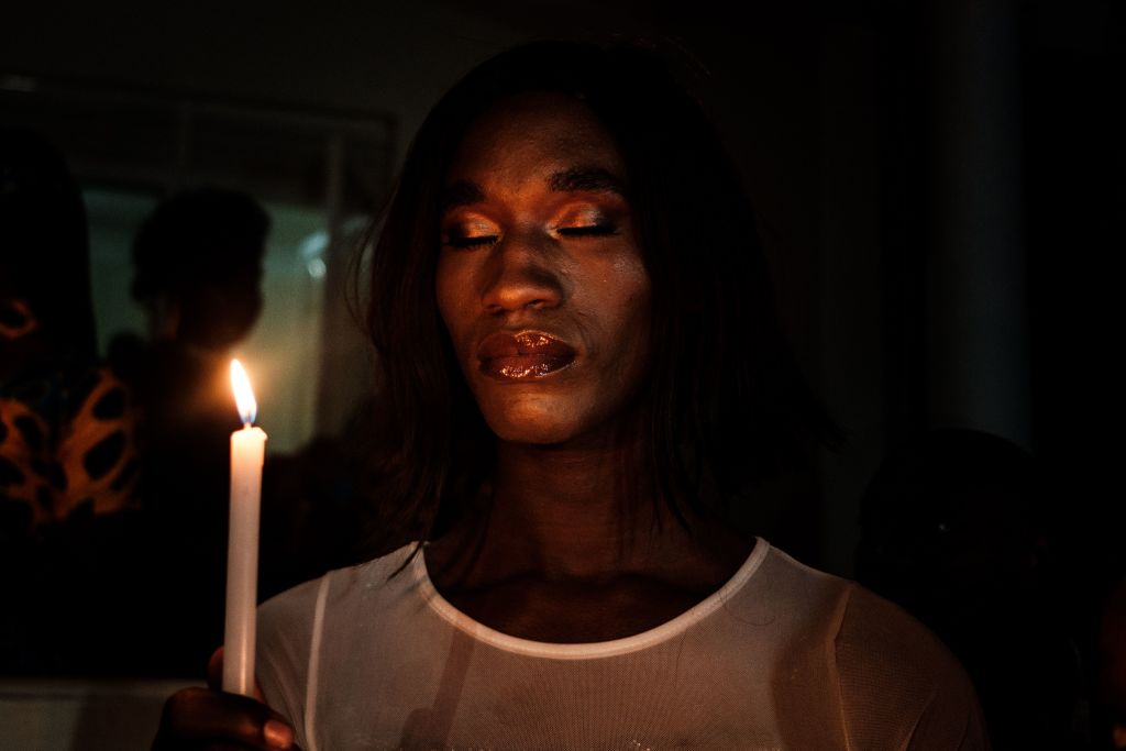 A member of the transgender and LGBTQ community holds candles during the vigil of the Transgender day of Remembrance in order to pay tributes to victims of hate crimes in Uganda and all over the world, in Kampala, Uganda. 