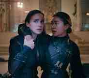 A still from Netflix series Warrior Nun showing actors Alba Baptista and Kristina Tonteri-Young as Ava and Beatrice wearing their warrior nun costumes; and Ava is supporting Beatrice in a room with bodies lying on the floor