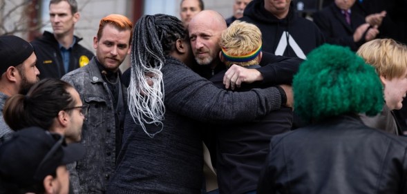 Club Q co-owner Nic Grzecka embraces mourners outside Colorado Springs City Hall.