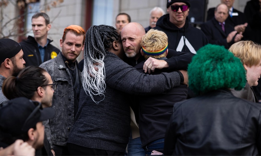 Club Q co-owner Nic Grzecka embraces mourners outside Colorado Springs City Hall.