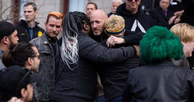 Club Q co-owner Nic Grzecka embraces mourners outside Colorado Springs City Hall.