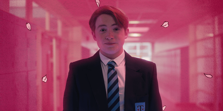 A still from Netflix's Heartstopper which shows Kit Connor as Nick Nelson wearing his school uniform