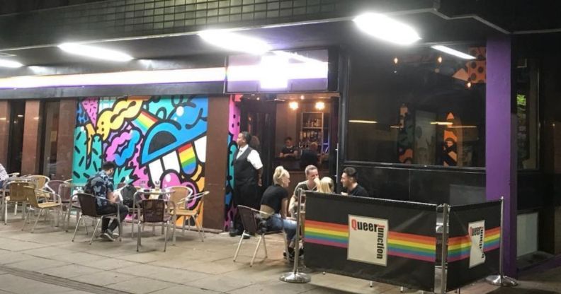 A photo of Sheffield gay club Queer Junction shows a group of people sat outside at one of its tables