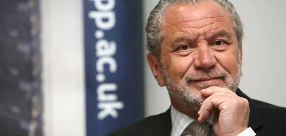 Alan Sugar in a promotional image. He is seen wearing a dark suit and tie.