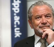 Alan Sugar in a promotional image. He is seen wearing a dark suit and tie.
