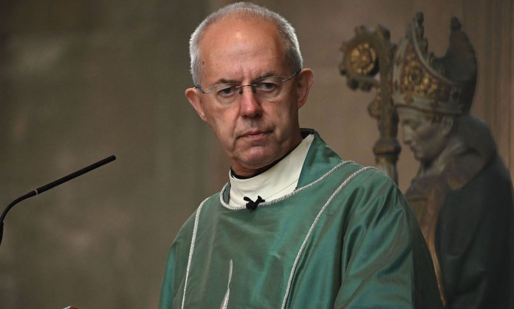 Archbishop of Canterbury, dressed in green robes, presides over a congregation.