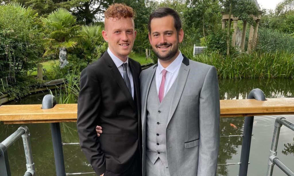 Ricardo and Bradleigh, a gay couple, wear suits and smile at the camera in an image shared as part of their promotion of fostering as a way to expand a family