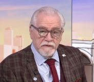 Brian Cox on Sunday with Laura Kuenssberg. He is pictured wearing a brown suit and a maroon tie with a blue shirt.