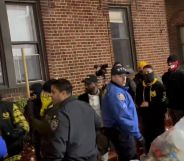 A group of Proud Boys members wearing masks are escorted by NYPD officers.