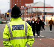 A policeman patrols in a high vis jacket around a city centre.