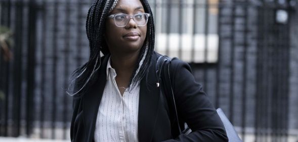 Kemi Badenoch walks across the streets of Number 10, wearing a black blazer.