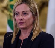 Italy's new prime minister Giorgia Meloni wears a dark outfit as she stares somewhere off camera