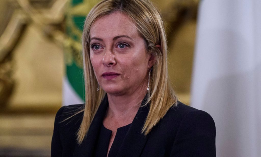 Italy's new prime minister Giorgia Meloni wears a dark outfit as she stares somewhere off camera