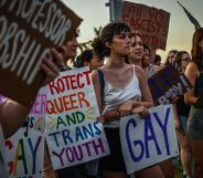 LGBTQ+ rights advocates gather around in protest of Ron DeSantis and the 'Don't Say Gay' bill in protest