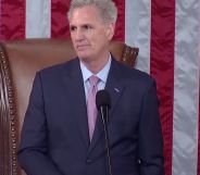 Republican congressman Kevin McCarthy, who is wearing a suit and tie, stands at a podium in front of the red, white and blue US flag as he's sworn in as speaker of the House of Representatives