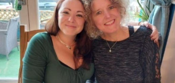 A photo shows married couple Rachael and Helen Patching sitting next to each other.