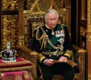 A photo of King Charles III sitting next to St Edward's Crown