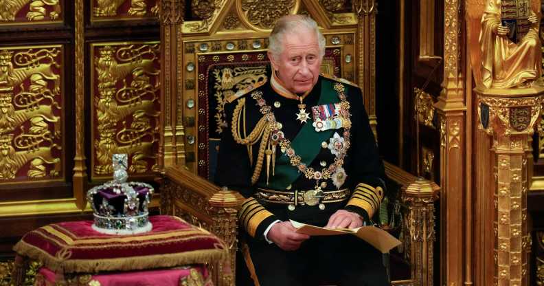 A photo of King Charles III sitting next to St Edward's Crown