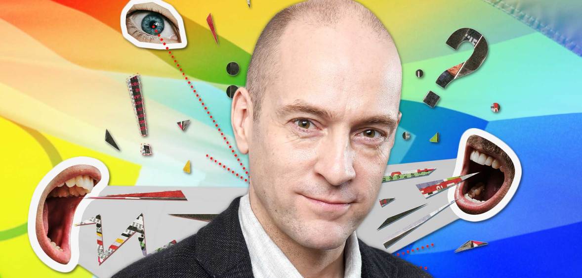 A graphic shows a cut-out image of magician Derren Brown surrounded by pictures of mouths shouting towards him and there's also a single eye looking at him. To the right of his head is a big question mark. The background is in rainbow Pride colours.