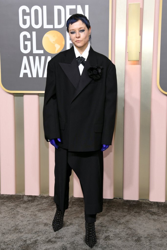 Emma D'Arcy in a black suit and skirt combo on the Golden Globes red carpet.