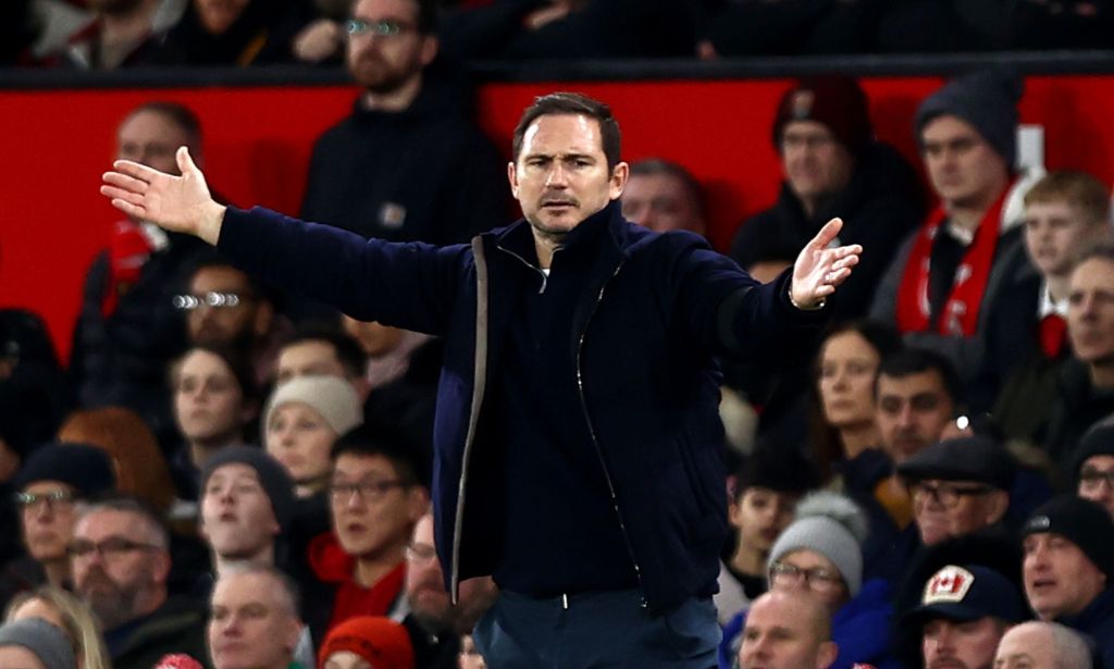 Frank Lampard waves his arms around during a match with a crowd behind him.
