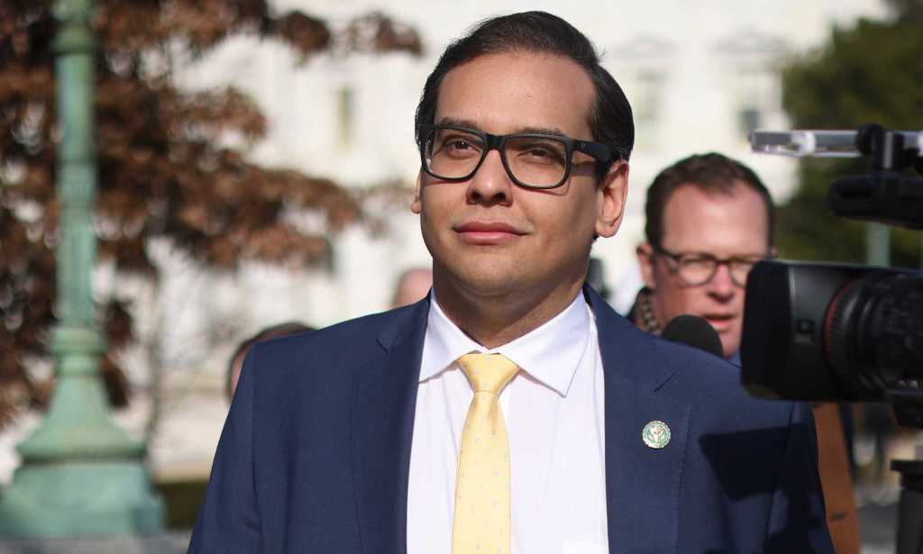 George Santos in a blue suit, white shirt and yellow tie