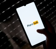 A photo shows a smartphone being held with the "PornHub" logo on a white background
