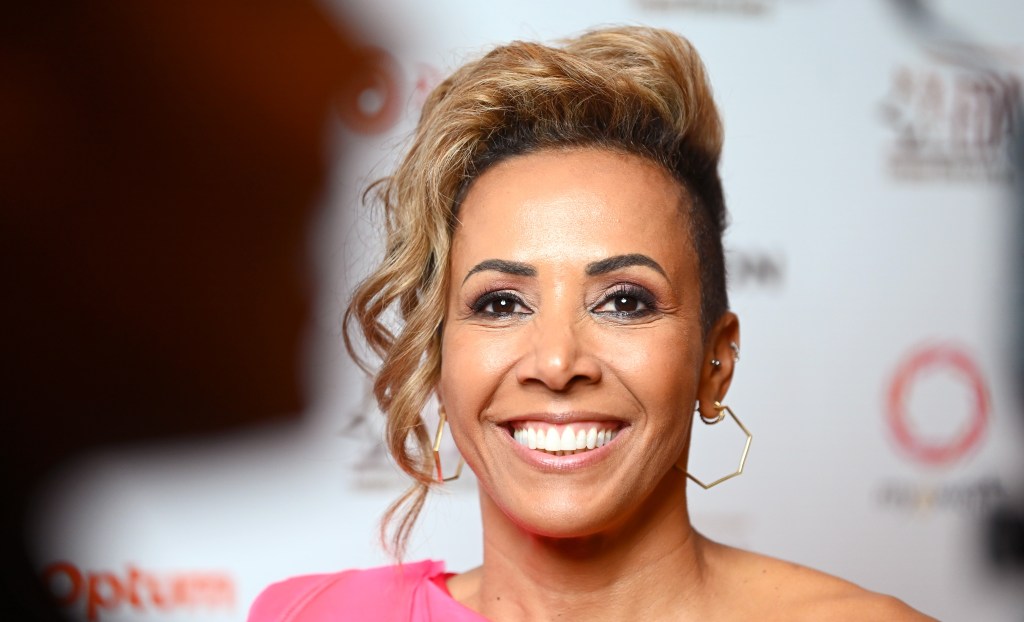 A close-up photo of athlete Dame Kelly Holmes wearing a pink dress as she attends the European Diversity Awards
