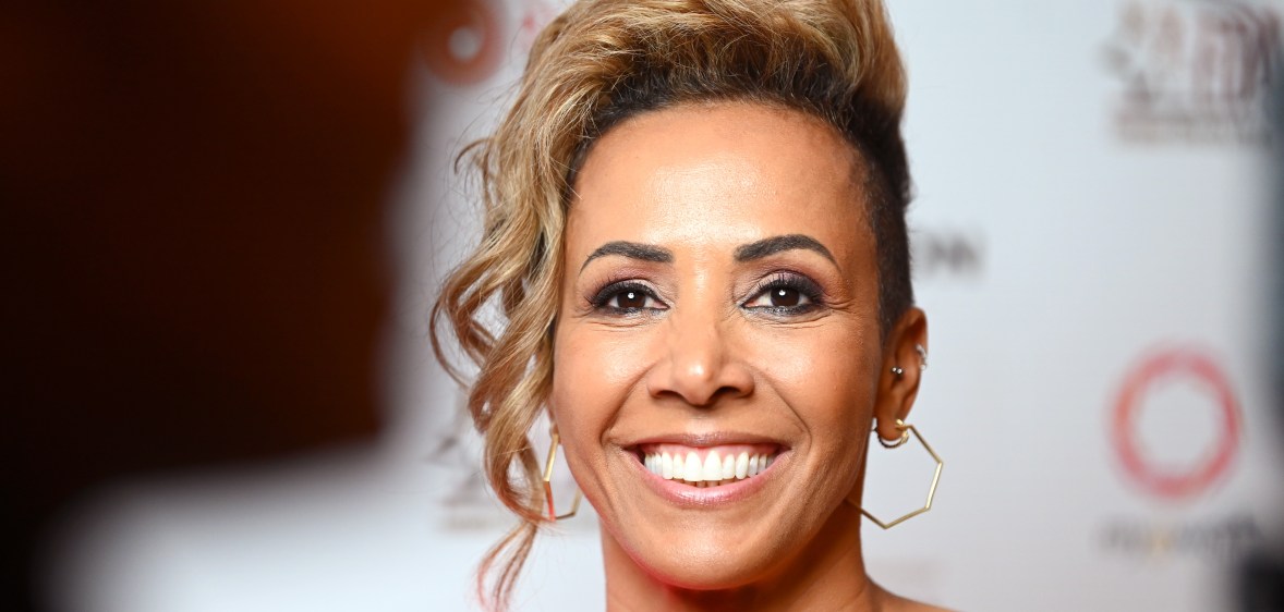A close-up photo of athlete Dame Kelly Holmes wearing a pink dress as she attends the European Diversity Awards